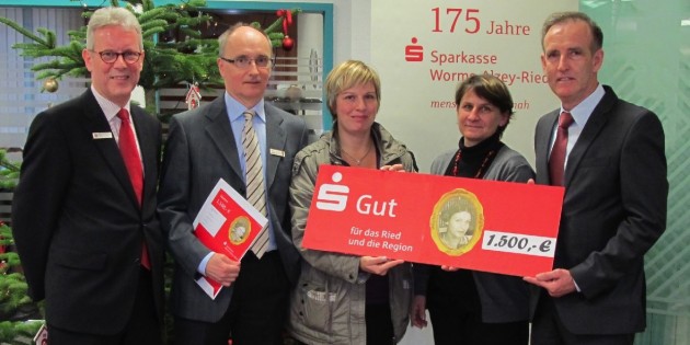 Gewinnerin Simone Tremmel (Mitte) übergibt die Spende an Pia Münch-Schmitz, Leiterin der Kindertagesstätte Schwalbennest (2.v.r.), und Hugo Kern, 2. Vorsitzender der Lebenshilfe Lampertheim (r.). Bei der Übergabe mit dabei waren Regionaldirektor Willi Sztorc (l.) und Kundenbetreuer Joe Doran (2.v.l.) von der Sparkasse Worms-Alzey-Ried und freuen sich mit den Gewinnern über das vorweihnachtliche Geschenk. Foto: oh