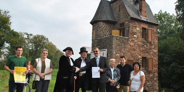 Bürgermeister Felix Kusicka übergab den Fährturm symbolisch an die in historischen Kostümen erschienenen Günther Mössinger alias Fährmann Wattenberg und Wilhelm Kreider alias Herr von Bach sowie Vertretern der Familie Kreider und des Heimat- und Geschichtsvereins Nordheim. Foto: Benjamin Kloos