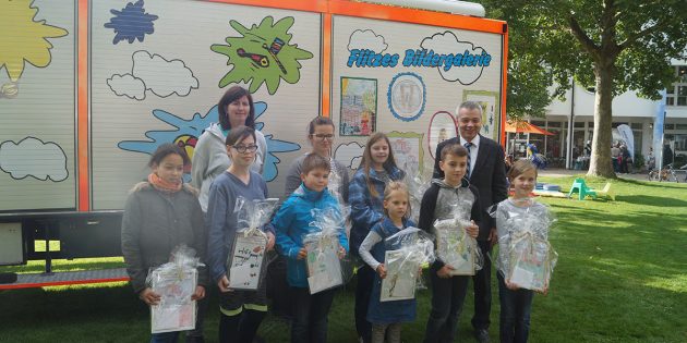 Die Gewinner des Malwettbewerbs zeigten sich stolz über das Ergebnis – die zehn Sieger-Kinder (leider nicht alle anwesend) konnten das neue Spielmobil Flitze Feuerstein mit ihren Bildern mitgestalten. Foto: Sigrid Samson