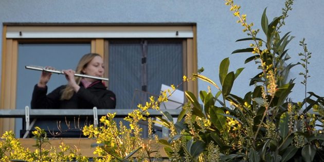 Querflötistin Melina Pauly spielt auf dem Balkon Beethovens „Ode an die Freude“. Alleine und doch gemeinsam machten die Mitglieder des Evangelischen Posaunenchors Hofheim am Sonntagabend bei der Aktion „Musiker für Deutschland“ mit. Foto: Petra Gahabka