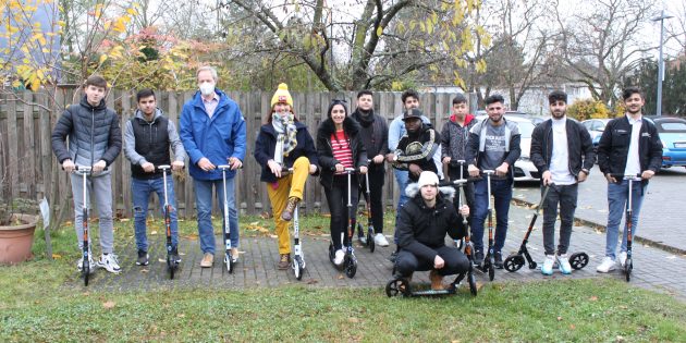 Die Jugendlichen der InteA Klasse dürfen sich ab sofort über Sportunterricht auf dem Scooter freuen. Stellvertretender Schulleiter Jürgen Ende (3. v. l.) und Sportlehrerin Edeltraud Schiertz (4. v. l.) wissen die Förderung durch das Land Hessen sehr zu schätzen. Foto: Nadine Schütz