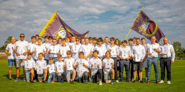 Die „Jungen Wilden“ und die „Flaggies“ der Bürstadt Redskins einmal ohne Helm und Trikot, mit Ehrenjugendleiter Bernd Fengel (ganz links), präsentieren stolz ihre Urkunden. Foto: Dirk Wilhelm, Redskins